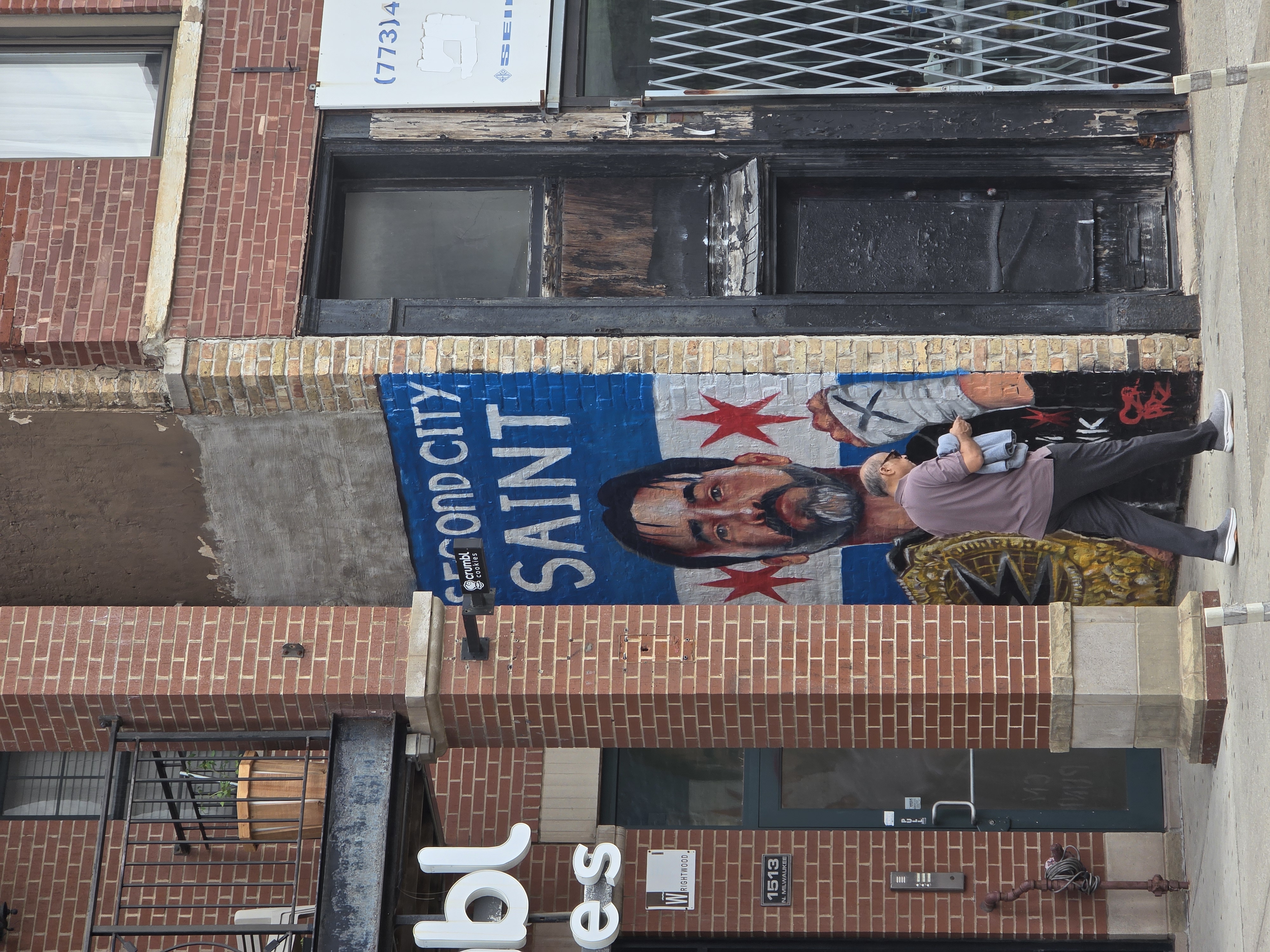 Second City Saint mural of CM Punk in a Chicago flag shirt on a brick building in Wicker Park